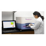 Technician operating a benchtop PCR analyzer in a lab